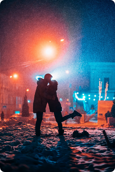 Screenshot 2026 05 01 at 09 18 56 Young adult couple in each others arms on snow covered street Free Photo